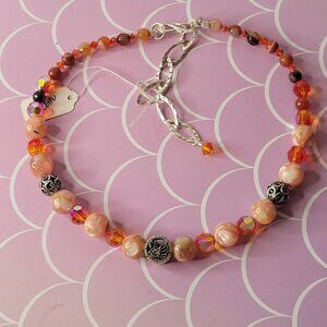 I am, a choker of sun stones and rock agate with a charm of a swan and crystals